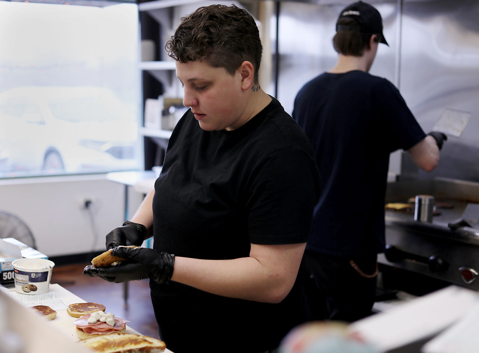 Vanessaโs daughter, Autumn Leitza, prepares a bagel sandwich